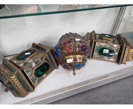 A PAIR OF GREEN AND CLEAR GLASS WALL LANTERNS TOGETHER WITH A PURPLE AND TURQUOISE GLASS AND BRASS LANTERN