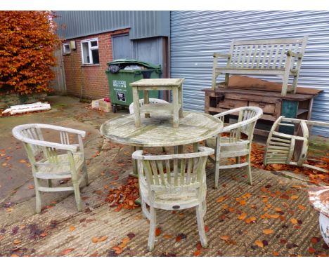 A COTSWOLD TEAK GARDEN TABLE WITH FIVE MATCHING CHAIRS, A SMALL COFFEE TABLE AND A SIMILAR BENCH.