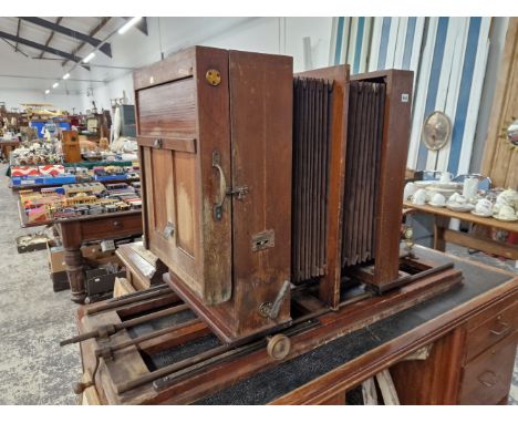 A LARGE AND IMPRESSIVE ANTIQUE MAHOGANY AND BRASS DOUBLE PLATE STUDIO CAMERA ON ADJUSTABLE RAIL BED.