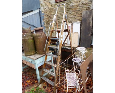 A WOODEN STEP LADDER.