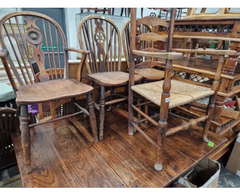 THREE WHEEL BACK CHAIRS AND A LADDER BACK ARM CHAIR. 