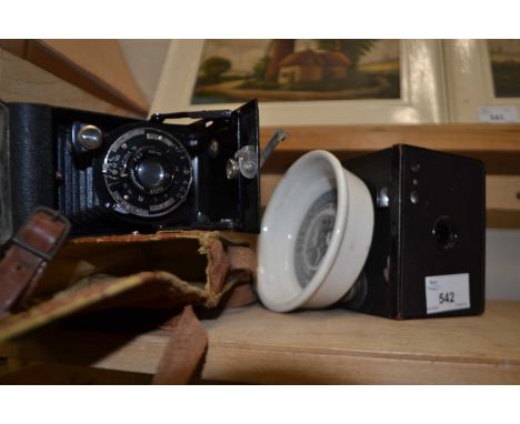 Boxed Brownie camera together with a Cherry toothpaste dish and another camera