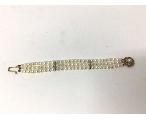 Cultured pearl bracelet with a triple strand of 6mm cultured pearls on a 9ct gold clasp, 18cm.Good condition. The pearls are 