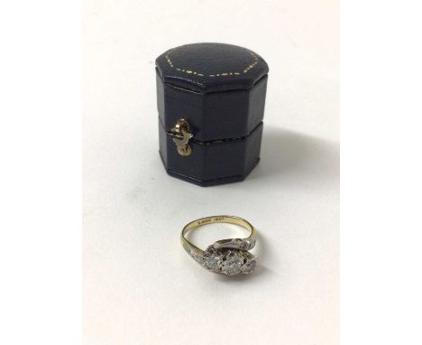 Diamond three stone ring with theee brilliant cut diamonds in platinum cross-over setting on 18ct yellow gold shank. Estimate