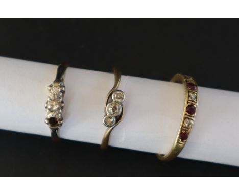 An 18ct gold three stone diamond ring, size M together with a two stone diamond ring, size K and an 18ct gold ruby and diamon