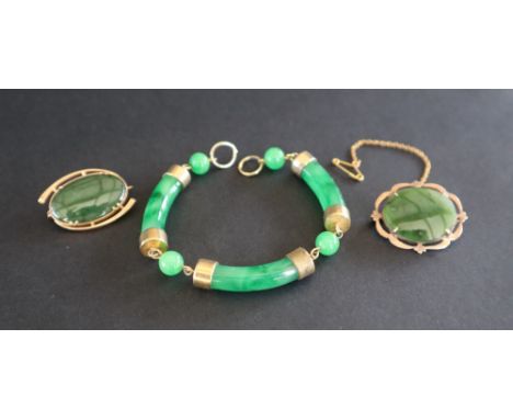 A green jade ball and bar gilt metal mounted sectional bracelet together with two 9ct gold mounted green jade brooches 