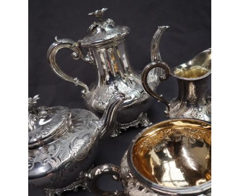 A Victorian silver four piece tea service comprising a hot water pot, teapot, cream jug and twin handled sugar basin, decorat