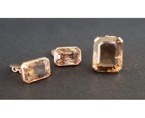 A citrine pendant of stepped rectangular form claw set in yellow metal together with a pair of citrine and yellow metal set c