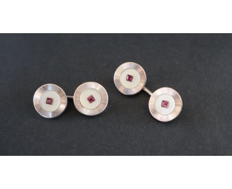 A pair of 9ct white gold cufflinks of circular form with central princess cut rubies, approximately 4.5 grams