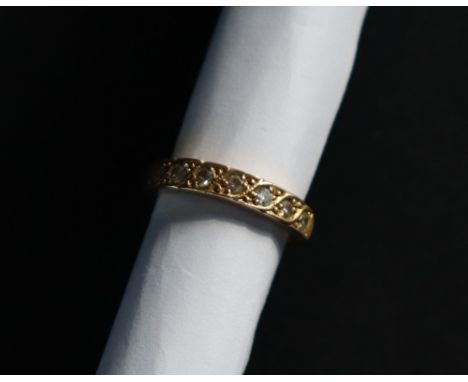 A diamond half eternity ring set with seven round brilliant cut diamonds to an 18ct yellow gold setting and shank, size K, ap