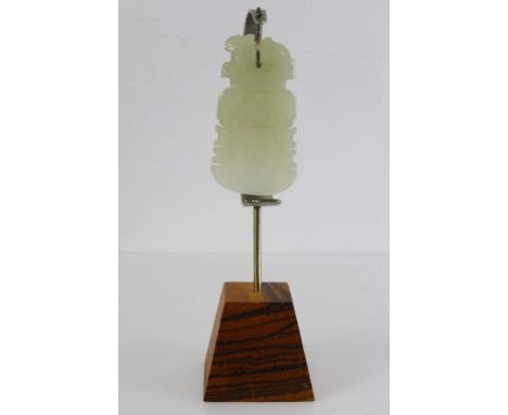 An Antique Chinese White Carved Jade Amulet, the amulet depicting a rabbit on a semi-circular cutting blade, the blade engrav
