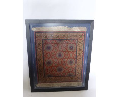 An Antique Silk and Fine Wool Prayer Carpet, with floral surround and a geometric central panel with rose medallions, framed 