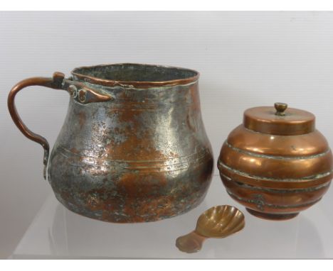 An Antique Copper Ale Jug, approx 13 cms high together with a sugar bowl and cover and a copper caddy spoon. (2)