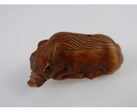 A Japanese Netsuke, in the form of a sow, approx 3 cms, with character marks to base.