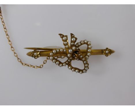 A Lady's 9 ct Gilded Seed Pearl Brooch, the brooch in the form of a bow, approx wt 7.5 gms..