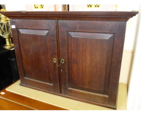 An Antique Oak Wall Cabinet, the cabinet having panelled doors and single shelf, approx 39 x 95 x 67 cms.