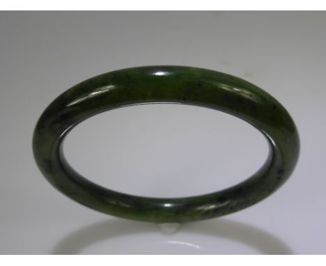 A Spinach Green Jade / Hardstone Bracelet, approx wt 41 gms, approx dia 7.5 cms.