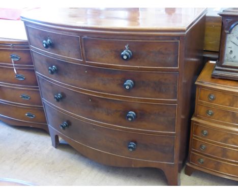 A Mahogany Chest of Drawers, bow fronted with two short and three long drawers, mother of pearl highlights to the drawer knob