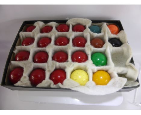 An Antique Set of Snooker Balls, in the original box together with a a Remy Martin Wooden Score Board. (2)