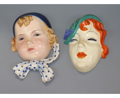 A Goldscheider face mask and another wall mask