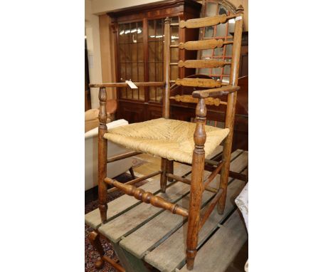 A provincial ladder back elbow chair