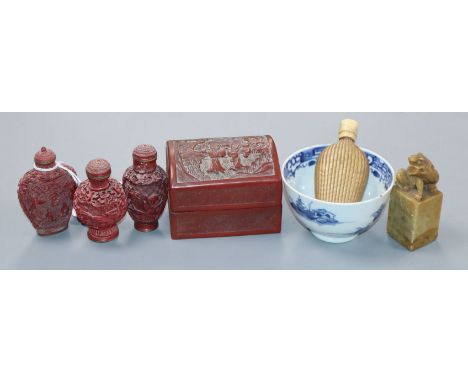 Four Chinese snuff bottles, a cinnabar box, a lion seal and a blue and white tea bowl