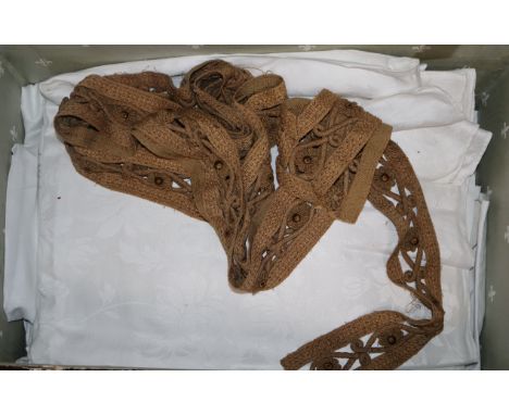 A late Victorian domed top trunk and large collection of linen and other tablecloths, etc.