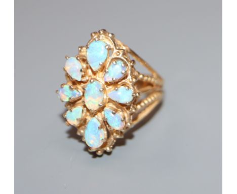 A yellow metal and opal mounted ring, unmarked