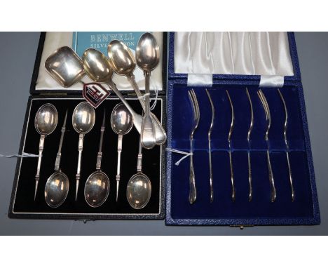 A cased set of six silver mote spoons, a cased set of six silver cake forks, three teaspoons and an enamelled caddy spoon, by