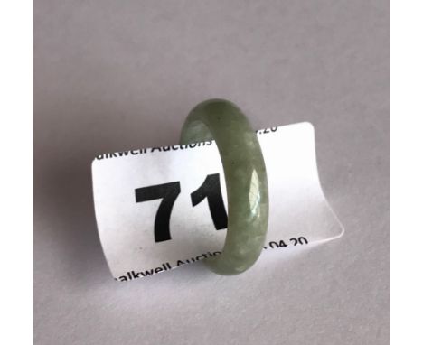 A fine pale celadon green jadeite jade wedding style ring. Band width 0.6cms internal dia. 1.8cms. Condition very good.