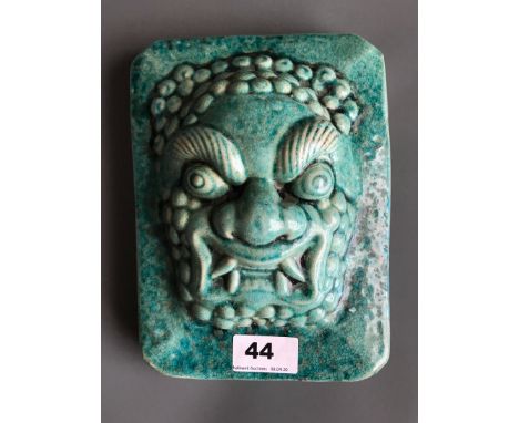 An interesting Chinese ceramic door guardian head with turquoise crackle glaze. H. 22cms W. 17cms D. 8.5cms. Condition excell