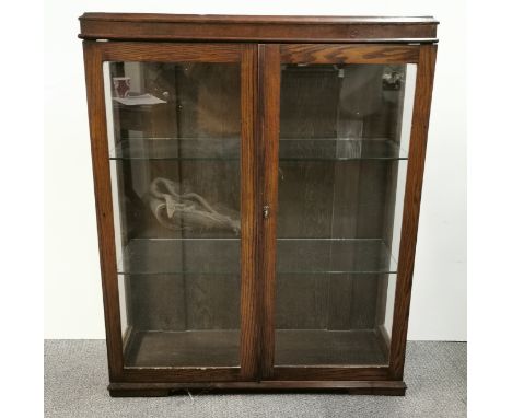 A glazed oak cabinet, size 93 x 115cm.