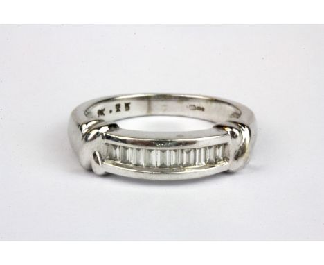 A 9ct white gold ring set with baguette cut diamonds, (L).