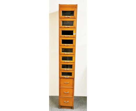 A vintage haberdashery cabinet of glass fronted drawers, W. 33cm H. 210cm.