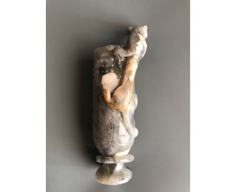 An impressive archaic form white and grey jade wine goblet with integral foot ring and young dragon handle. H. 21cm. Conditio