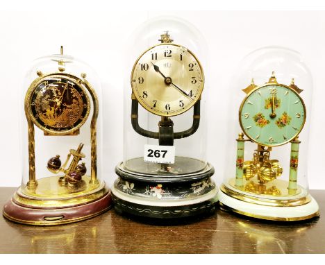 Two vintage enamelled torsion pendulum clocks with glass domes and a vintage Bulle clock with magnetic pendulum, overall tall