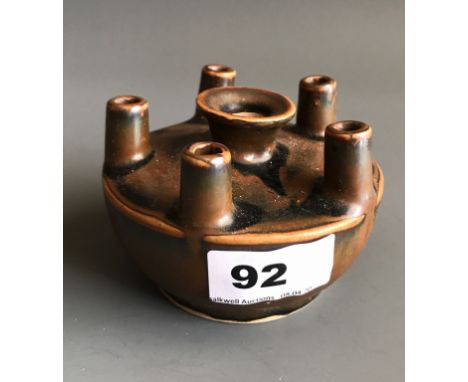 A Chinese Song Dynasty style brown glazed pottery oil lamp for five wicks. D. 10cms. Condition good.