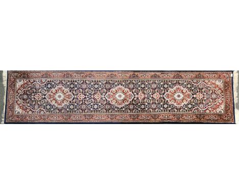 A dark blue brown heavy quality wool runner, W. 74cm L. 300cm.