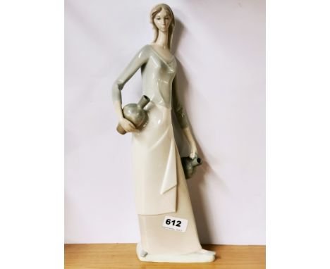 A large porcelain Nao figure of a girl with two jugs, H. 39cm.