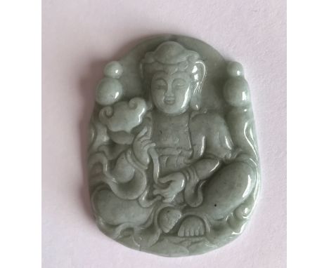 A finely carved jade amulet of the seated goddess Guanyin holding a ruyi. W. 4cms. Condition excellent.