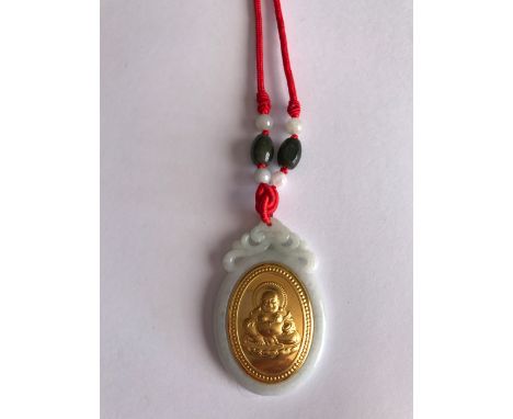 A modern carved jade amulet inset with a yellow metal, tested high carat gold, image of Putai, the Happy Buddha. Set on a sil