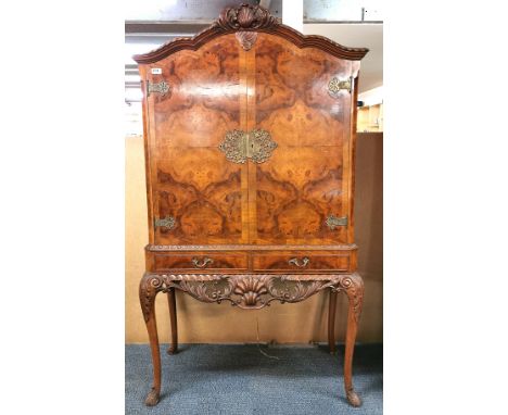 A burr walnut veneered drinks cabinet with an extending cocktail slide, 90 x 45 x 160cm.