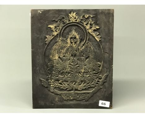 A Tibetan carved wooden panel with decoration of a seated Tara used for hand printing prayer flags. 29 x 36 x 2cms.