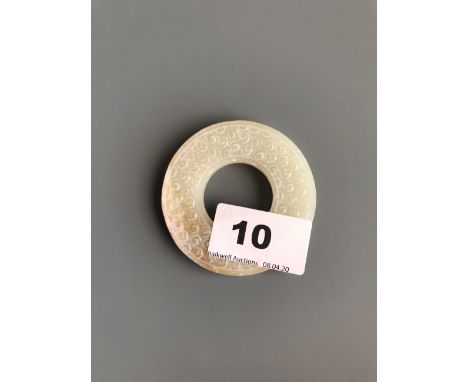 A finely carved jade pi disc. D. 6.2cms. Condition excellent.