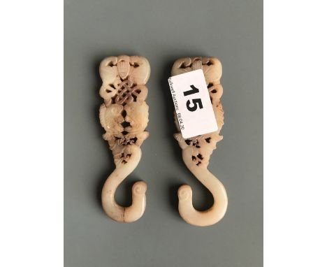 A pair of 19th/early 20thC carved nephrite jade/hardstone hooks. H. 10cms. Condition good but possible small repair to bottom