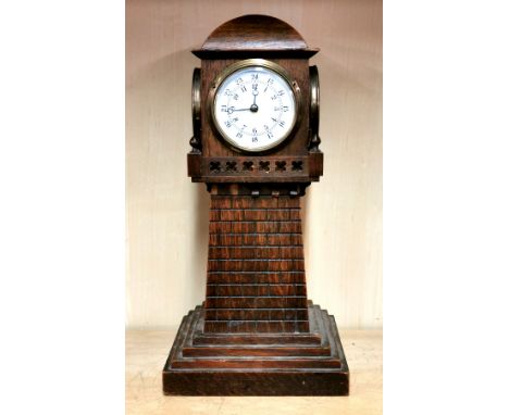 A four sided oak lighthouse clock, with alarm movement on the base, H. 38cm. Condition : small parts of the oak case missing 