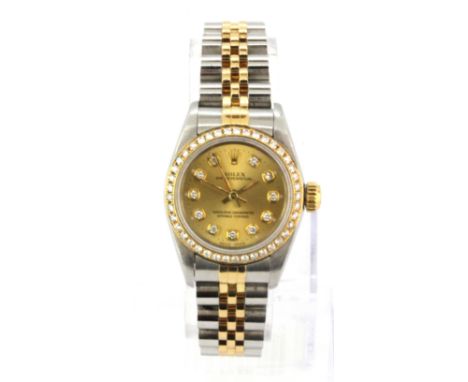 A lady's stainless steel Rolex gilt wrist watch with diamond set bezel and face. Understood to be in good working condition.