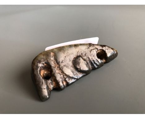 An important archaic form dark green/black jade amulet resembling a stylised head. H. 6.5cms. Private collection and understo