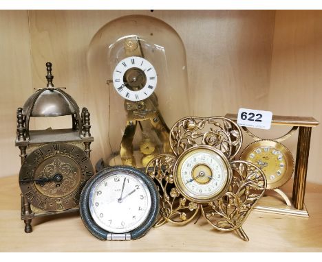 A group of four mixed alarm and mantle clocks with an exhibition style skeleton clock and dome by Holt &amp; Co, shamrock clo