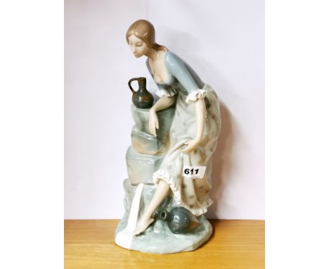 A large Nao porcelain figure of a girl beside a spring, H. 33cm.